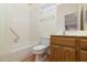 Clean bathroom with shower/tub combo and wood vanity at 9007 E Emerald Dr, Sun Lakes, AZ 85248