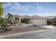 One-story house with tile roof, desert landscaping, and two-car garage at 9007 E Emerald Dr, Sun Lakes, AZ 85248