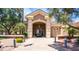 Attractive building exterior with arched entryway and landscaping at 9007 E Emerald Dr, Sun Lakes, AZ 85248