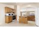 Kitchen boasts oak cabinets, an island, and a gas range at 9007 E Emerald Dr, Sun Lakes, AZ 85248