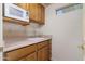 Small kitchen with microwave, sink, and wood cabinets at 9007 E Emerald Dr, Sun Lakes, AZ 85248