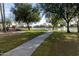 Peaceful lakeside walking path with lush greenery at 9007 E Emerald Dr, Sun Lakes, AZ 85248