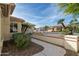 Landscaped walkway leading to the house with desert plants at 9007 E Emerald Dr, Sun Lakes, AZ 85248