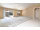 Living area with vaulted ceiling, carpet, and sliding glass doors at 9007 E Emerald Dr, Sun Lakes, AZ 85248