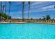 Refreshing community pool with lounge chairs and patio tables at 9007 E Emerald Dr, Sun Lakes, AZ 85248