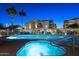 Inviting resort-style pool and spa area with palm trees at 920 E Devonshire Ave # 4005, Phoenix, AZ 85014