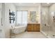 Bright bathroom features soaking tub, glass shower, and modern vanity at 9248 E Desert Village Dr, Scottsdale, AZ 85255