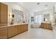 Luxurious bathroom with double vanities, a soaking tub, and modern fixtures at 9248 E Desert Village Dr, Scottsdale, AZ 85255