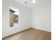 Bedroom with hardwood floors and a view of the front yard at 9248 E Desert Village Dr, Scottsdale, AZ 85255