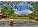 Scenic community lawn area featuring a central water feature, lush landscaping, and mountain views at 9248 E Desert Village Dr, Scottsdale, AZ 85255