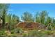 Scenic community entrance sign surrounded by mature desert landscaping showcasing natural beauty at 9248 E Desert Village Dr, Scottsdale, AZ 85255