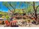 Relaxing community space with mature trees, stone waterfall feature, and comfortable seating areas at 9248 E Desert Village Dr, Scottsdale, AZ 85255