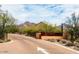 Inviting entrance to The Gateway community, featuring mountain views, desert landscaping, and a clear road at 9248 E Desert Village Dr, Scottsdale, AZ 85255