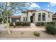 Stunning two-story home featuring a tile roof, desert landscaping, and an attached garage at 9248 E Desert Village Dr, Scottsdale, AZ 85255