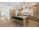 Contemporary kitchen with a large island, modern appliances, and stylish pendant lighting at 9248 E Desert Village Dr, Scottsdale, AZ 85255