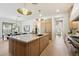 Large kitchen island with stone countertop and wood cabinets at 9248 E Desert Village Dr, Scottsdale, AZ 85255