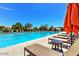 Community pool perfect for relaxing with lounge chairs and shaded umbrellas at 9248 E Desert Village Dr, Scottsdale, AZ 85255