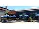 Eggstasy restaurant with outdoor seating, umbrellas, and contemporary facade for an enjoyable dining experience at 9248 E Desert Village Dr, Scottsdale, AZ 85255