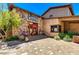 Charming exterior view of Grimaldi's Pizzeria with stone accents, red door, and inviting entrance at 9248 E Desert Village Dr, Scottsdale, AZ 85255