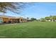 Large grassy backyard with view of the back of the house at 9614 W Long Hills Dr, Sun City, AZ 85351