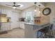 Kitchen boasts granite countertops and a breakfast bar with seating at 9614 W Long Hills Dr, Sun City, AZ 85351