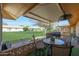 Covered patio with seating area, grill, and view of grassy backyard at 9614 W Long Hills Dr, Sun City, AZ 85351