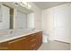 Double vanity bathroom with modern wood cabinets at 1 E Lexington Ave # 908, Phoenix, AZ 85012