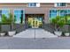 Modern building exterior with glass windows, entrance, and landscaping at 1 E Lexington Ave # 908, Phoenix, AZ 85012