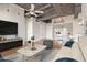 Living room with hardwood floors, TV, and modern furniture at 1 E Lexington Ave # 908, Phoenix, AZ 85012