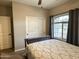 Cozy bedroom with full-size bed and window with curtains at 10315 W Rosemead Dr, Casa Grande, AZ 85194