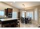 Kitchen with island, breakfast nook, and white shutters at 10315 W Rosemead Dr, Casa Grande, AZ 85194