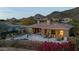 Luxury home with pool and mountain views at dusk at 11127 E Mirasol Cir, Scottsdale, AZ 85255