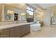 Luxurious bathroom with soaking tub, double vanity, and large mirror at 11127 E Mirasol Cir, Scottsdale, AZ 85255
