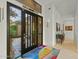 Bright and spacious entryway with a large black front door, colorful rug, and artwork at 11127 E Mirasol Cir, Scottsdale, AZ 85255