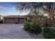 Beautiful home exterior with three car garage and desert landscaping at 11127 E Mirasol Cir, Scottsdale, AZ 85255