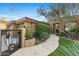 Landscaped entryway to a beautiful home with a custom iron gate at 11127 E Mirasol Cir, Scottsdale, AZ 85255