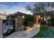 Elegant home exterior with landscaped walkway, gate, and lighting at 11127 E Mirasol Cir, Scottsdale, AZ 85255