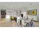 Modern kitchen with white cabinets, large island, and breakfast bar at 11127 E Mirasol Cir, Scottsdale, AZ 85255