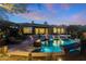 Inviting pool and spa with fire pit, lights, and mountain views at 11127 E Mirasol Cir, Scottsdale, AZ 85255