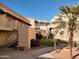 Community courtyard with grassy area, trees, and stairs leading to building entrances at 12221 W Bell Rd # 259, Surprise, AZ 85378
