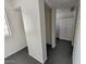 Hallway featuring tile flooring, neutral walls, and access to built in storage at 12221 W Bell Rd # 259, Surprise, AZ 85378