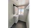 The laundry area features a stacked washer and dryer, a window, and tile floors at 12221 W Bell Rd # 259, Surprise, AZ 85378