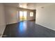 Open living room featuring tile flooring, neutral walls, and access to a patio via sliding glass doors at 12221 W Bell Rd # 259, Surprise, AZ 85378