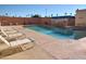 Community swimming pool with lounge chairs and a spa at 12221 W Bell Rd # 259, Surprise, AZ 85378