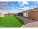 Expansive grassy backyard with a curved border at 15100 W Pierson St, Goodyear, AZ 85395