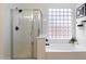 Bathroom with shower, bathtub, and large window at 15100 W Pierson St, Goodyear, AZ 85395