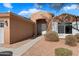 Tan house exterior with three-car garage and walkway at 15100 W Pierson St, Goodyear, AZ 85395