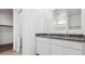 Bathroom with double vanity, granite countertops, and walk-in closet at 1543 E Lardner Dr, Casa Grande, AZ 85122