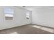Spacious bedroom with neutral carpeting and two windows at 1543 E Lardner Dr, Casa Grande, AZ 85122
