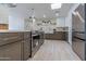 Modern kitchen with dark cabinetry, stainless steel appliances, and a breakfast bar at 1644 W Thunderbird Rd, Phoenix, AZ 85023